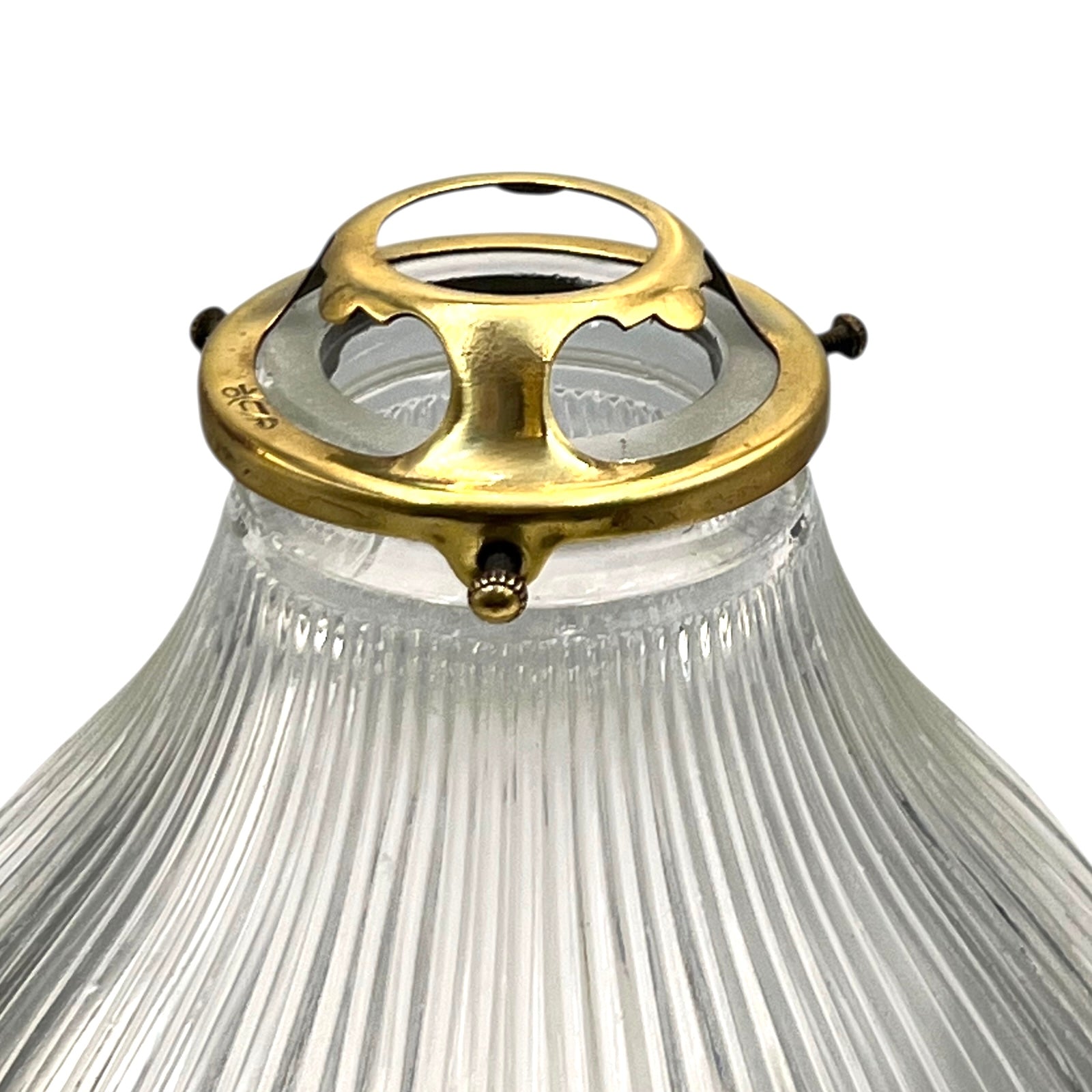 Clear glass lampshade with gold metal fitting on a white background