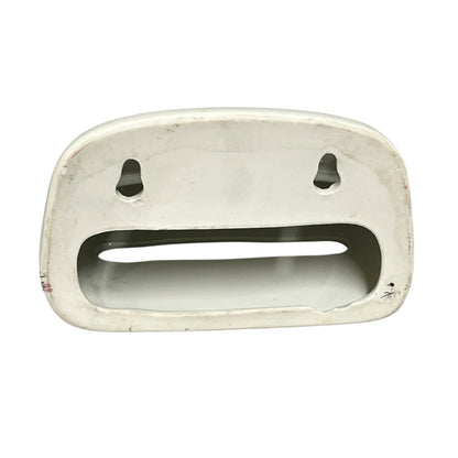 The back of a toiler tissue holder shown against a plain white background.