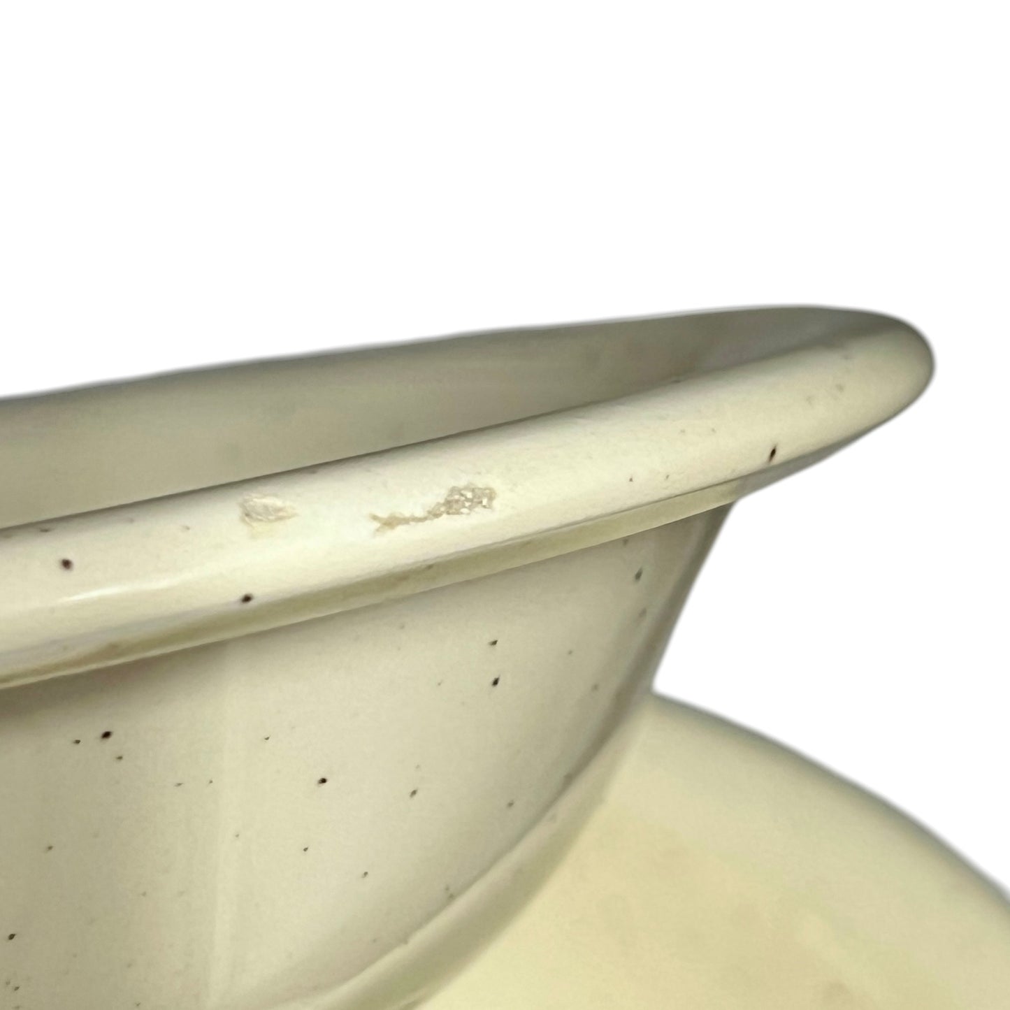 Close-up of a beige ceramic bowl with speckled texture on a white background