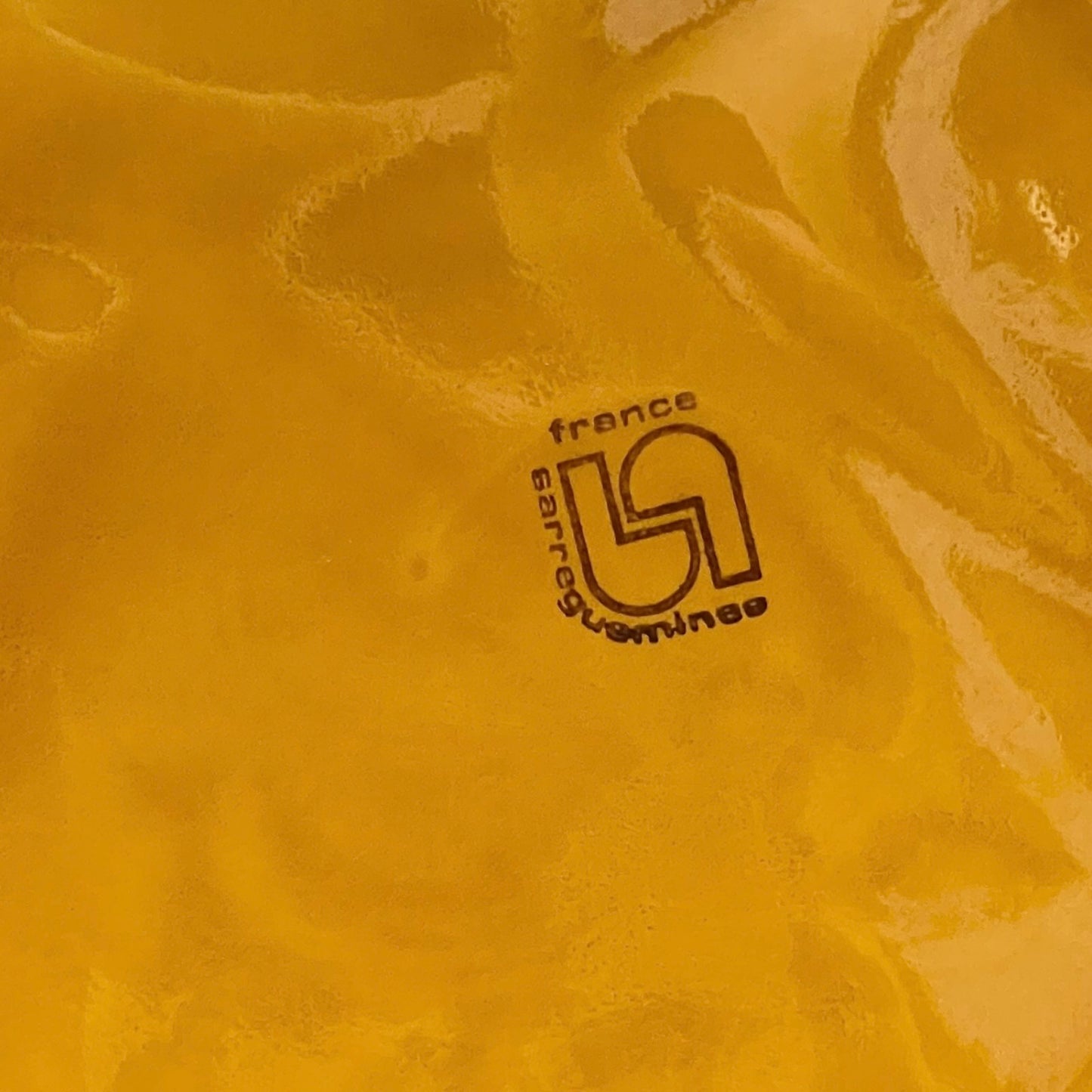 Back of fondue plate showing makers stamp on a white background