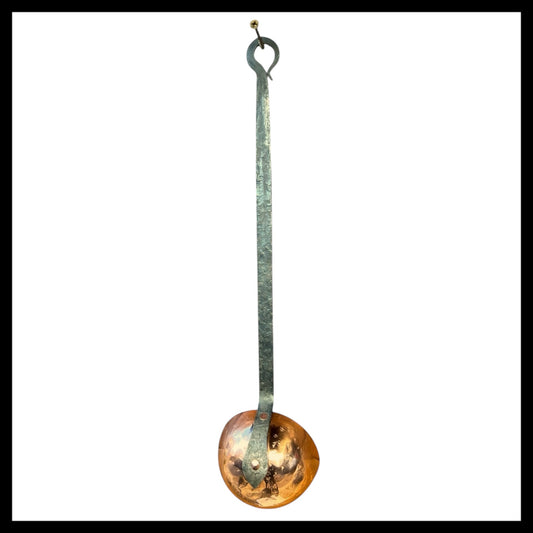 Vintage copper long handled ladle with a hanging hoop and a polished copper end