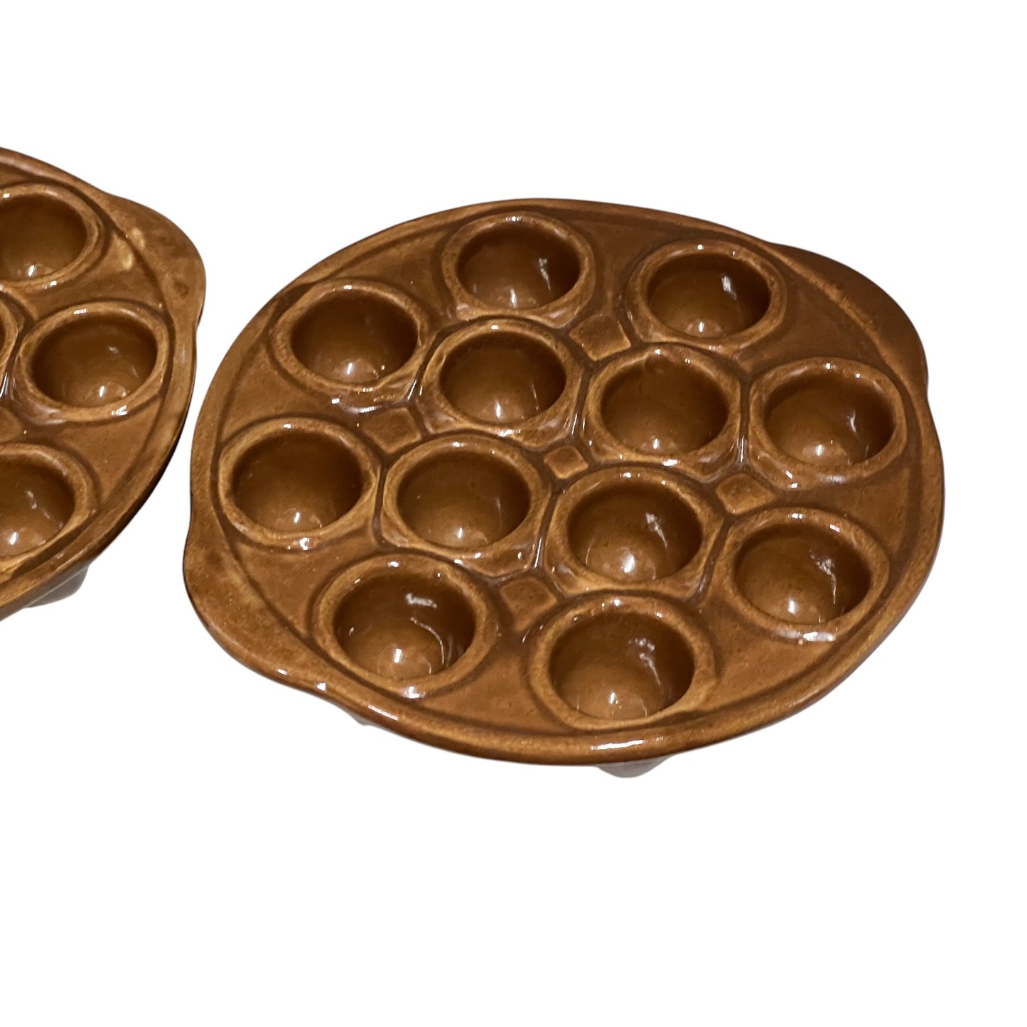Close-up of a French escargot serving plate against a white background.