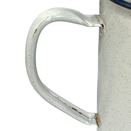 Close-up of a enamel planter with speckled pattern on a white background