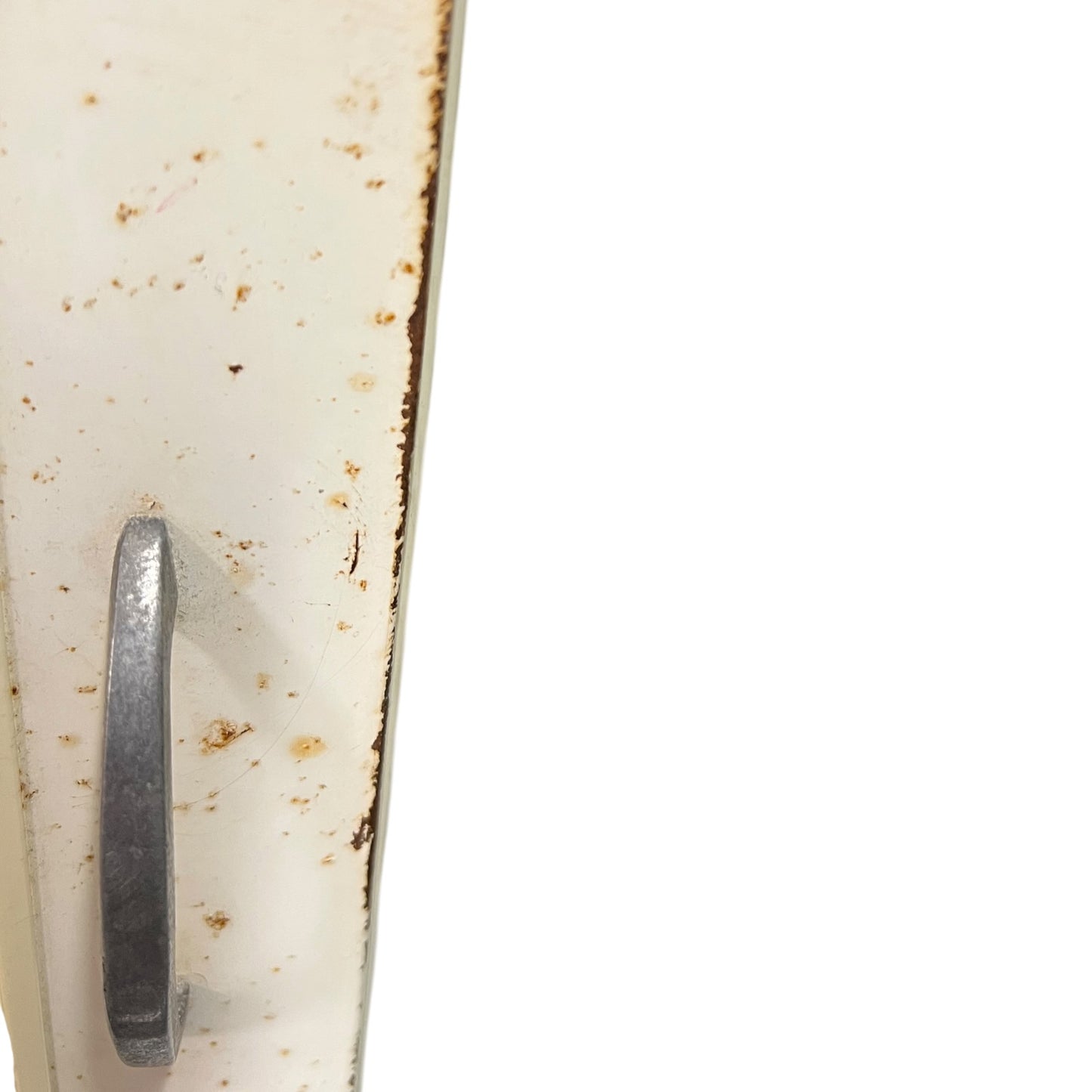 close up of a vintage metal bathroom cabinet on a white background