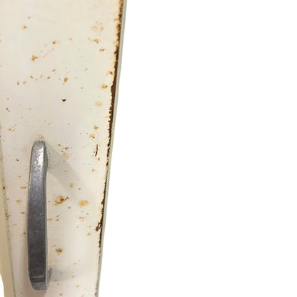 close up of a vintage metal bathroom cabinet on a white background