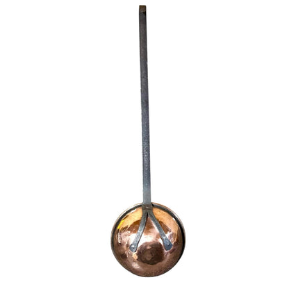 A copper ladle with a long, straight dark metal handle, shown vertically against a plain white background.