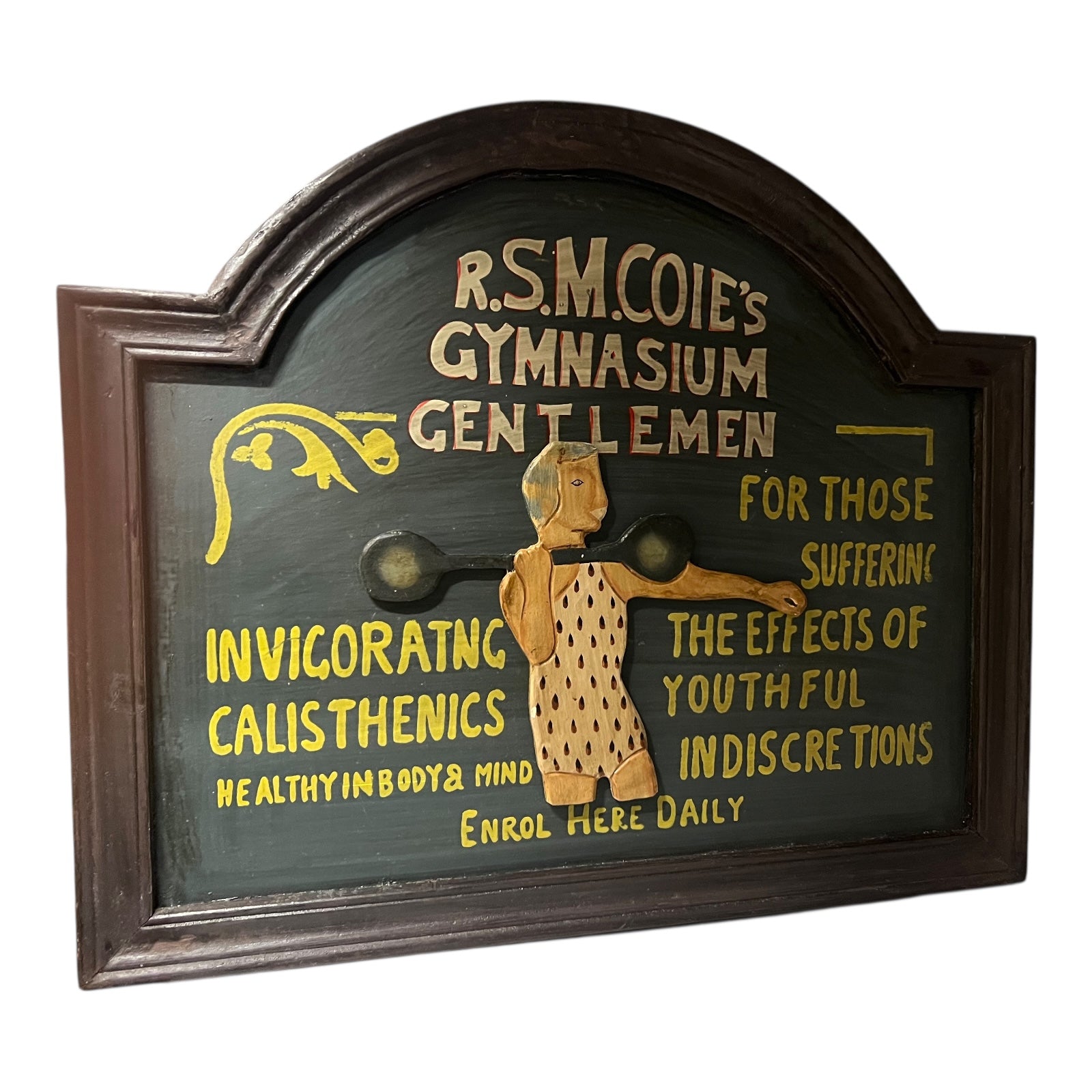 Vintage-style gymnasium sign with text and illustration of a person exercising, framed in dark wood.
