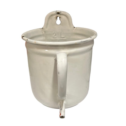 A vintage white enamel plant pot with a built-in handle, a side handle, and a small spout, shown against a plain white background.