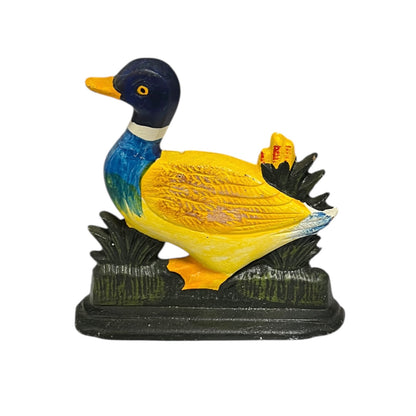 Colourful cast iron duck doorstop on a white background