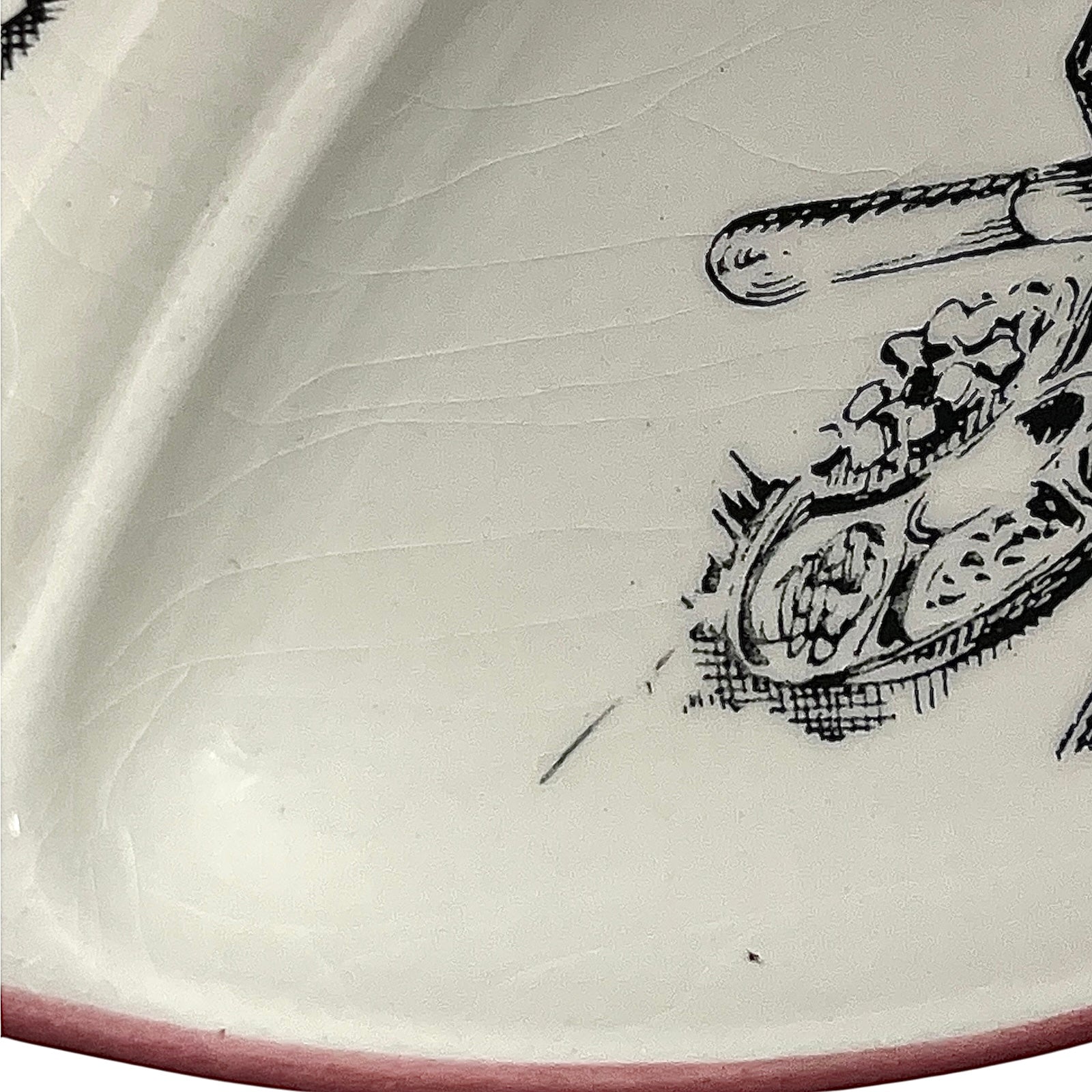 Close-up of a vintage fondue plate with detailed design on a white background