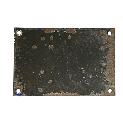 Rust-covered metal plate with four holes on a white background
