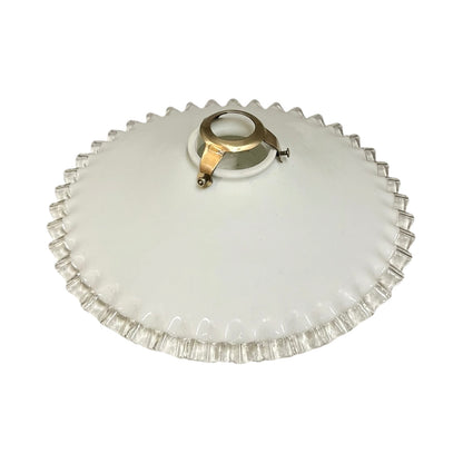 French vintage milk glass opaline lampshade with a clear trimmed frilly edge and a brass bulb holder ideal for a French country style set on a white background