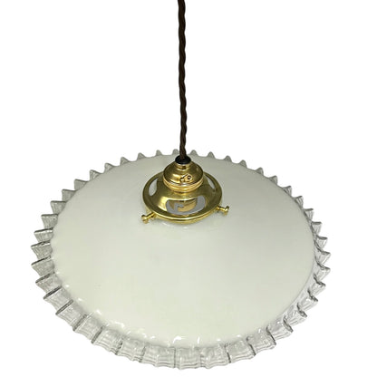 Vintage-style pendant light with white glass shade and brass fitting on a white background