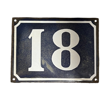 Blue and white door number 18 set on a white background 