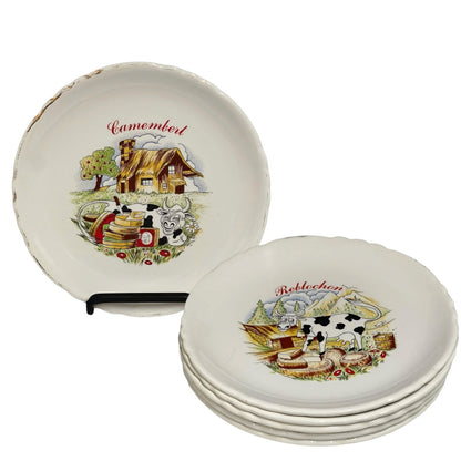 Set of ceramic cheese plates with farm-themed designs on a white background
