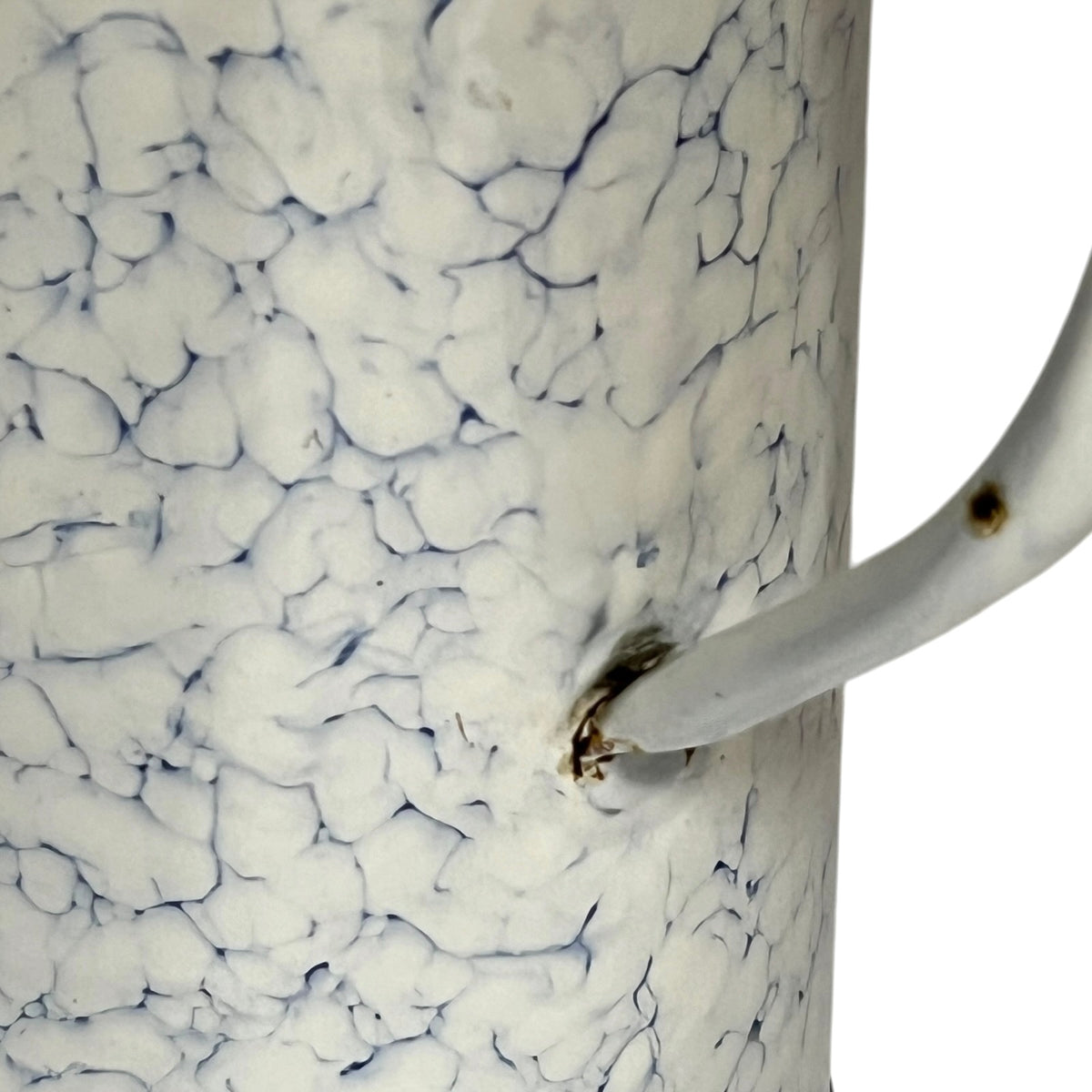 Close-up of a white irrigator with a blue crackle glaze pattern and a white handle, shown against a white background.