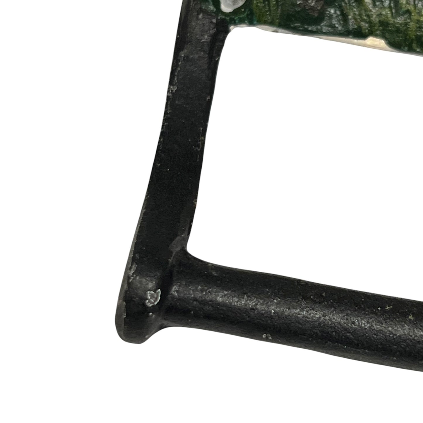 close up of cast iron toiler roll holder on a white background