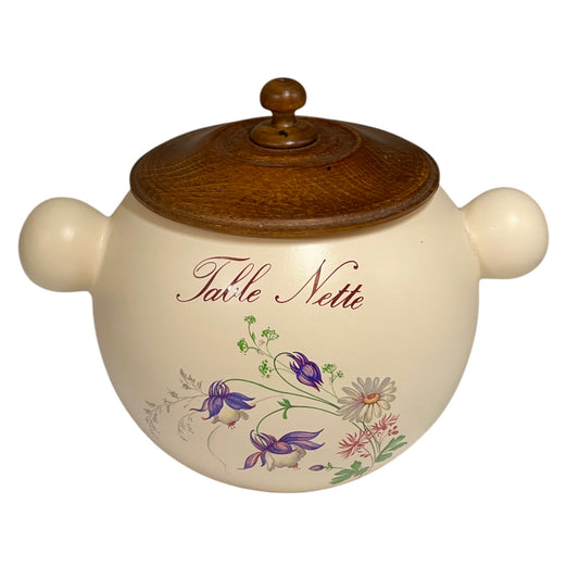 Ceramic jar with wooden lid featuring floral designs and 'Tarte Nette' text on a white background