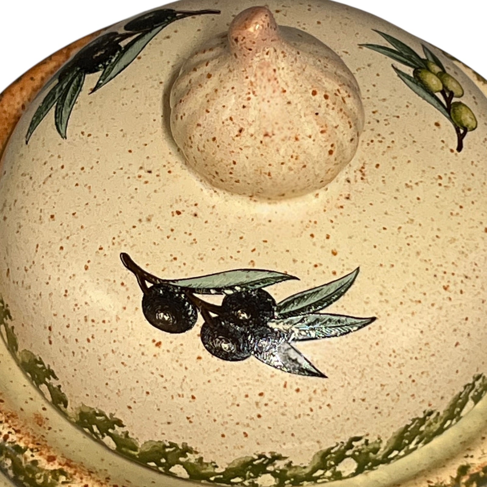 Close-up of a ceramic jar with embossed design on a white background