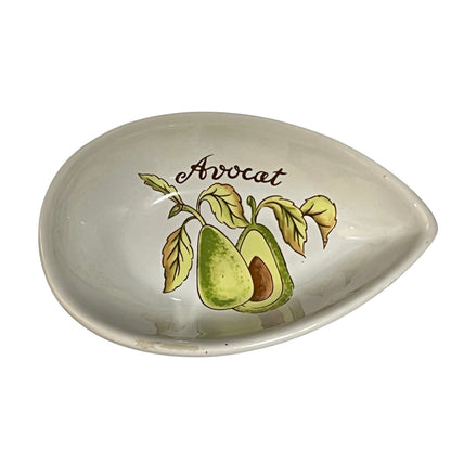 An oval ceramic dish with a teardrop-shaped pointed end, featuring a printed illustration of an avocado and the word 'Avocat' in brown script on a white background.