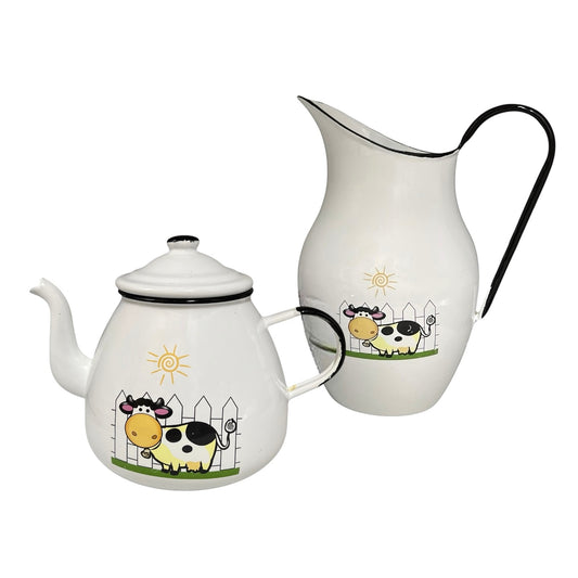 Teapot and pitcher set with cow illustrations on a white background