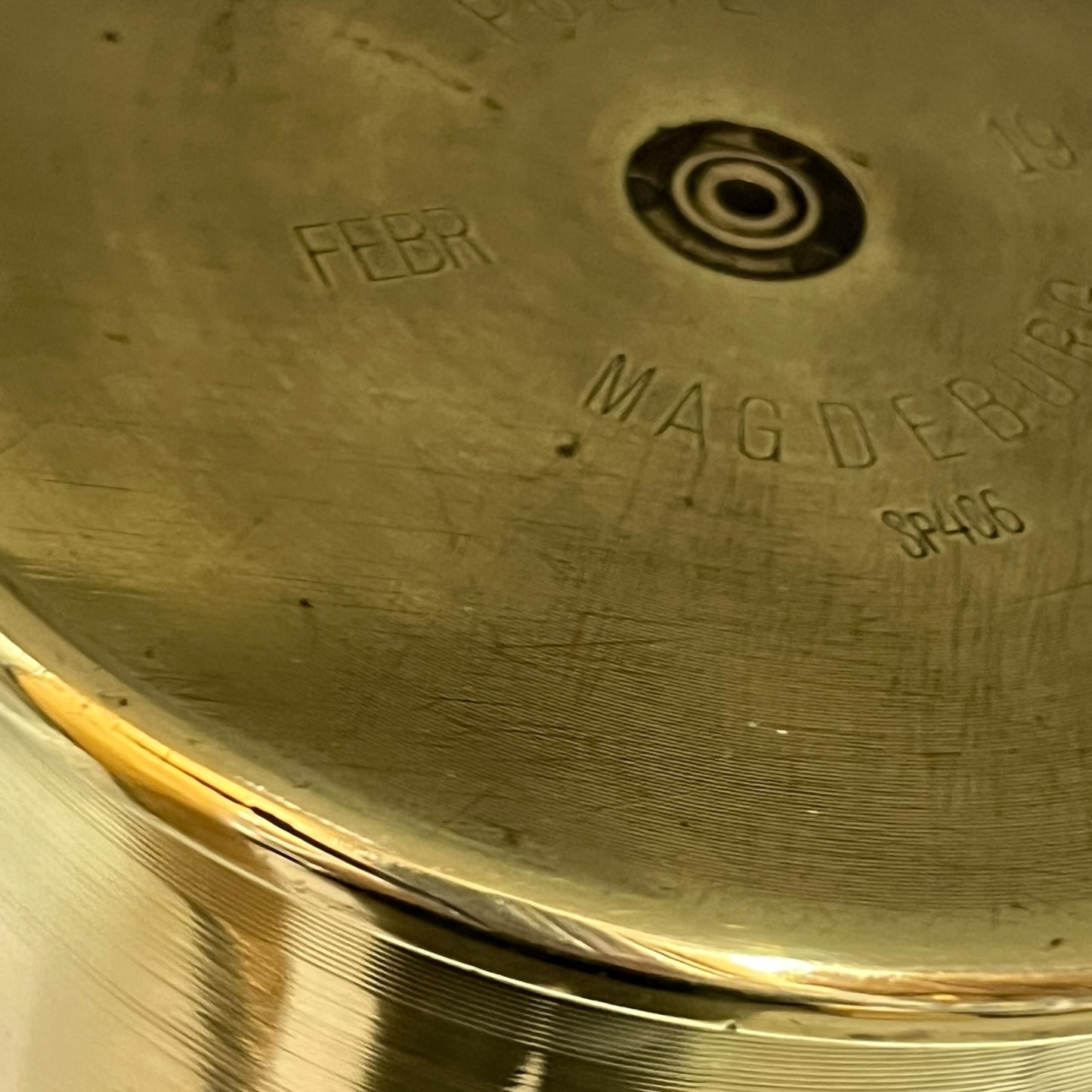 Close up of a brass WW1 German shell case on a white background