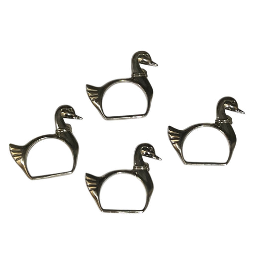 Four silver plated swan shaped napkin rings on a white background
