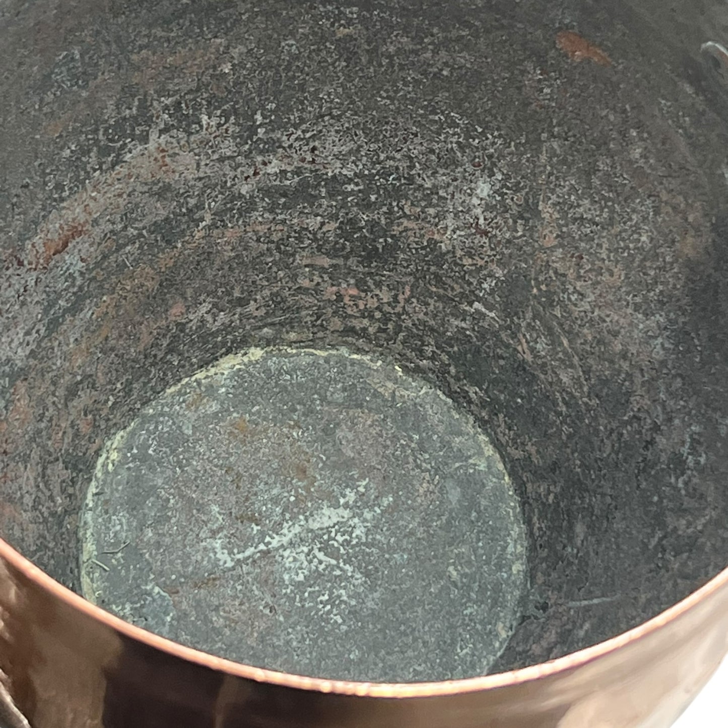 Inside of a copper cooking pot stockpot with handles on a white background