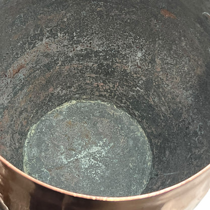 Inside of a copper cooking pot stockpot with handles on a white background