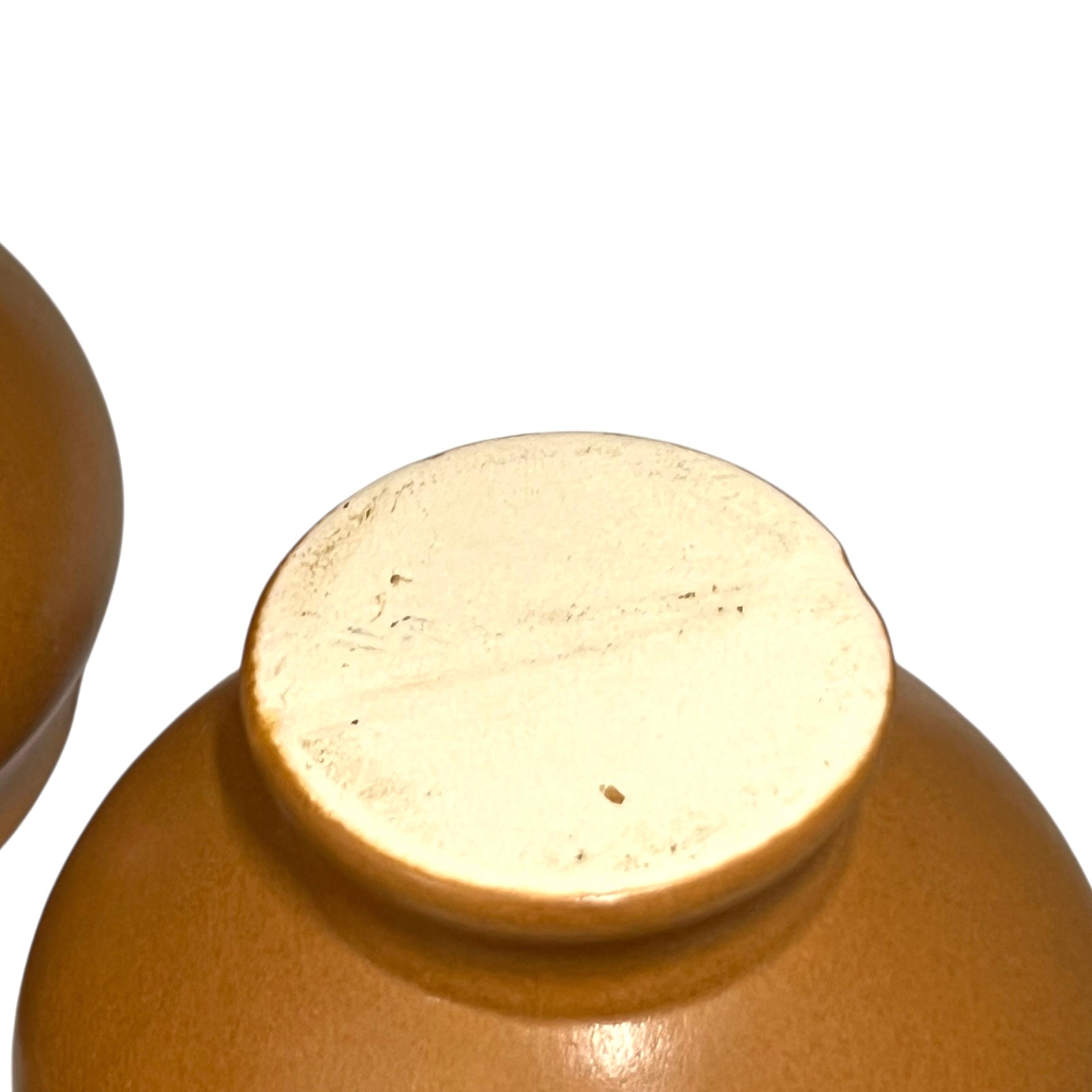 light brown ceramic French soup bowls with lions head handles on a white background 