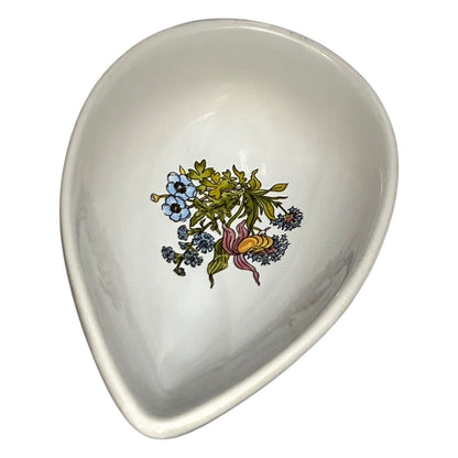 teardrop-shaped ceramic dish with floral design on a white background