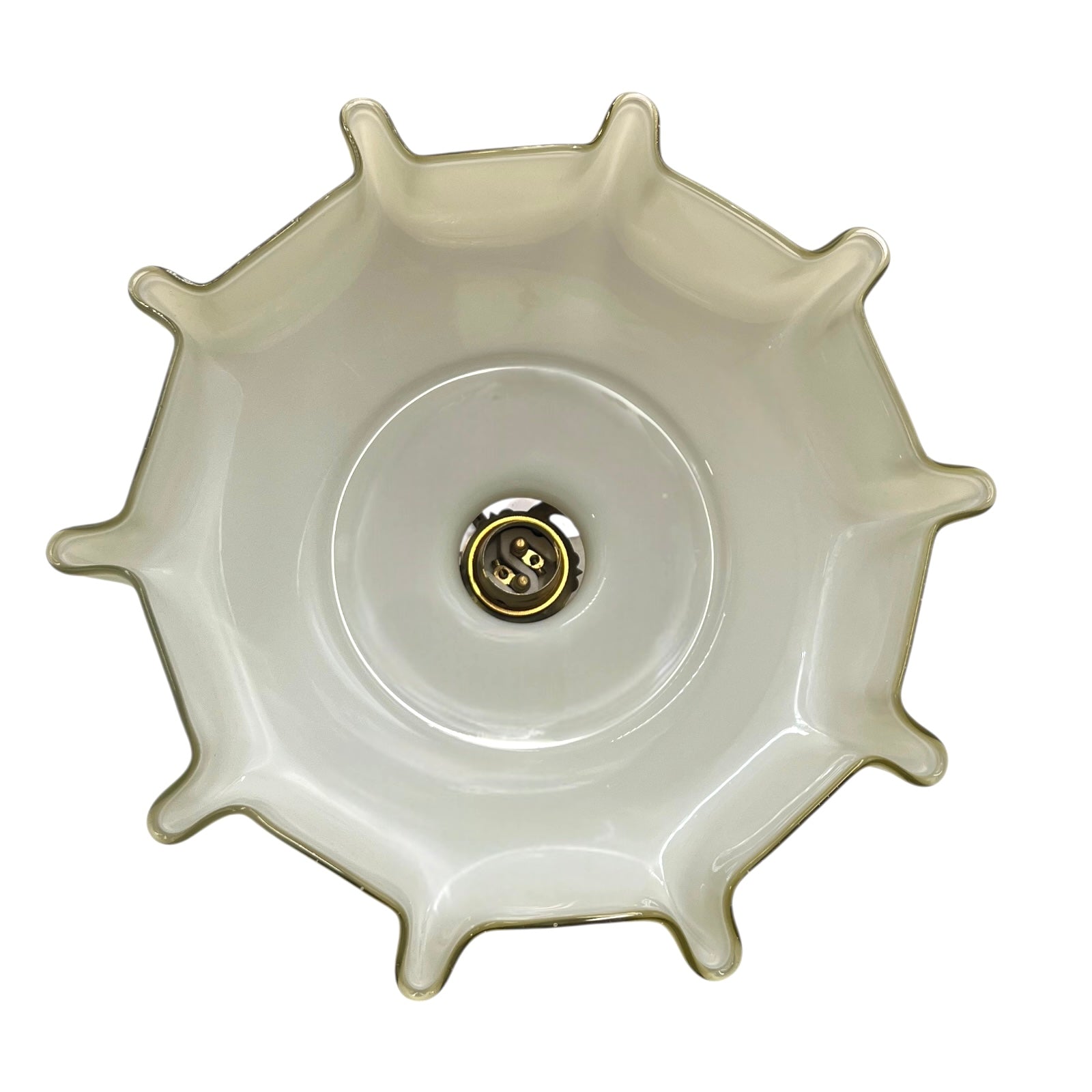 Close-up of a milk glass shade interior with a brass bulb holder on a white background