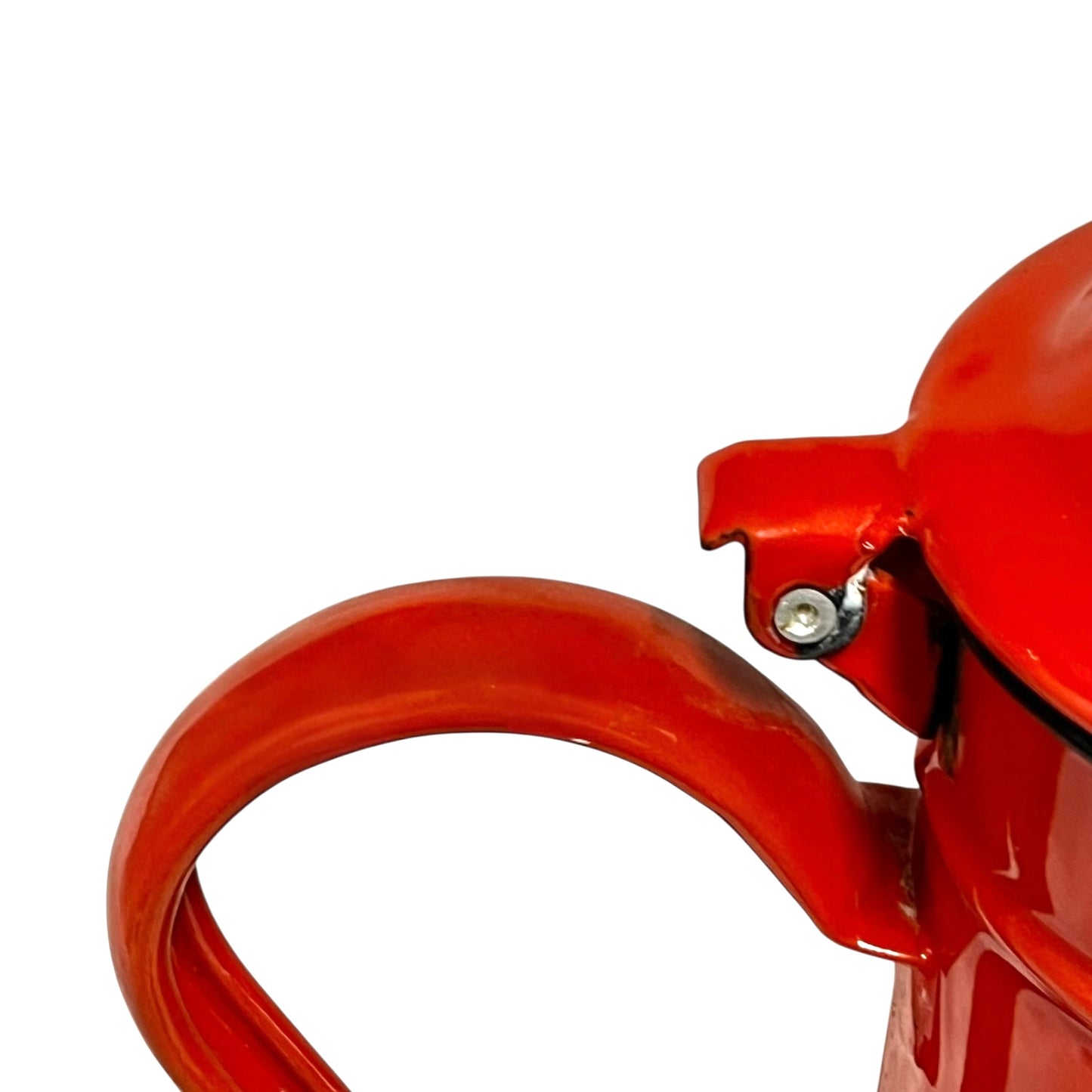 Close up of a red vintage French enamelled coffee pot on a white background