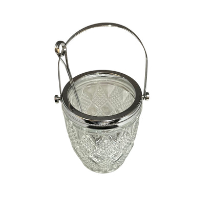 Clear glass ice bucket with silver scoop and handle on a white background