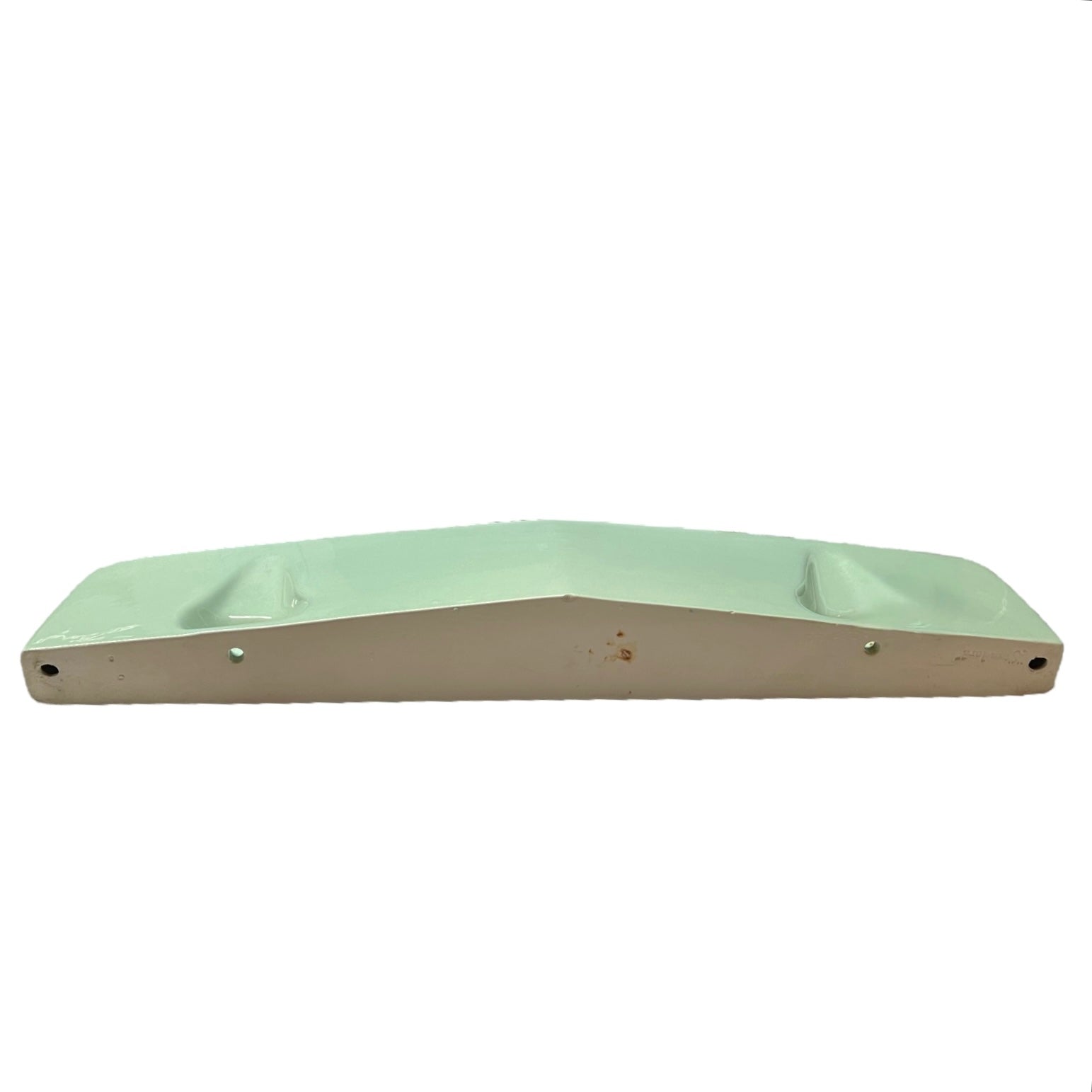 back view of pale green ceramic shelf on a white background