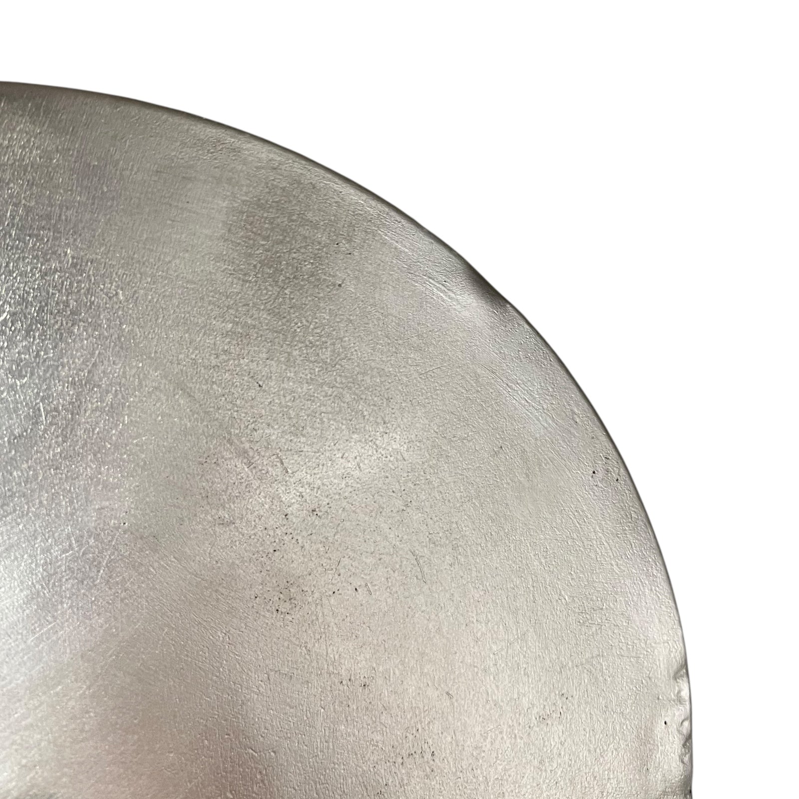 Close up French copper pan lid showing hand wiped traditional new tin lining  on a white background