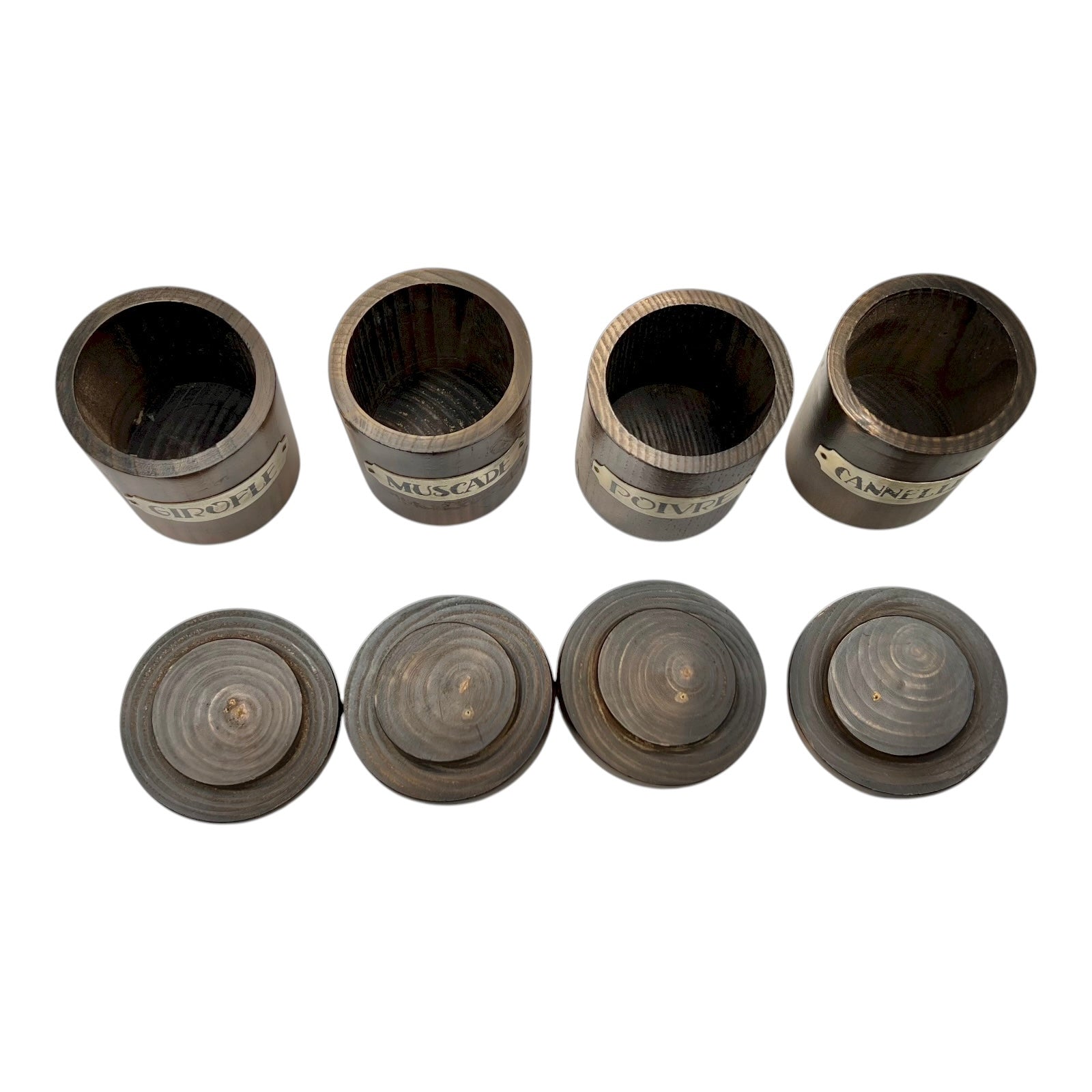 inside view of 4 wooden spice jars with lids n a white background