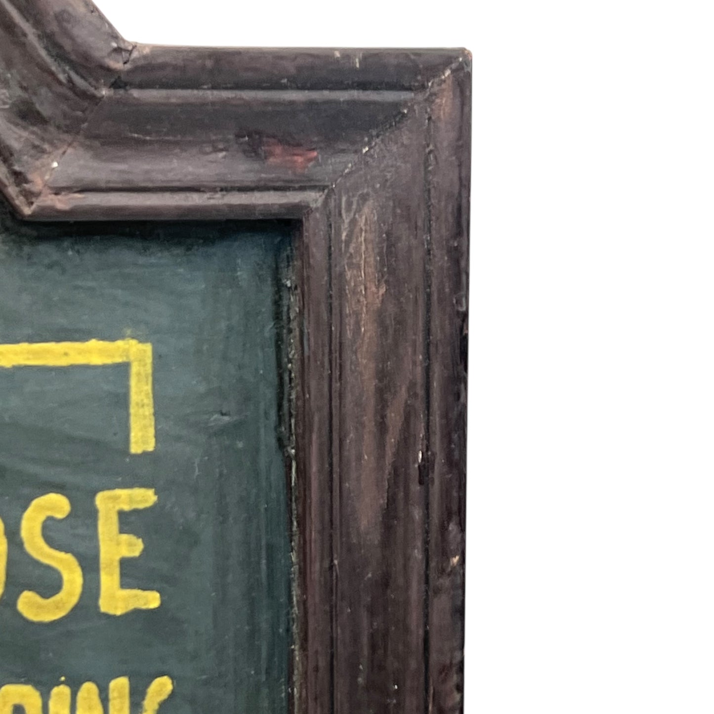 Corner of a framed picture with a dark brown frame and green interior.