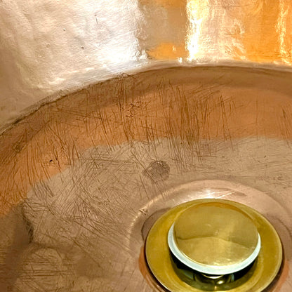 Close-up of a metallic surface with a drain cover