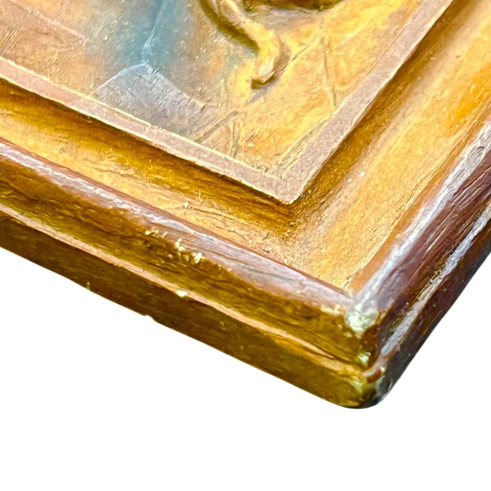 close up of wooden relief sculpture in an arts and crafts style on a white background