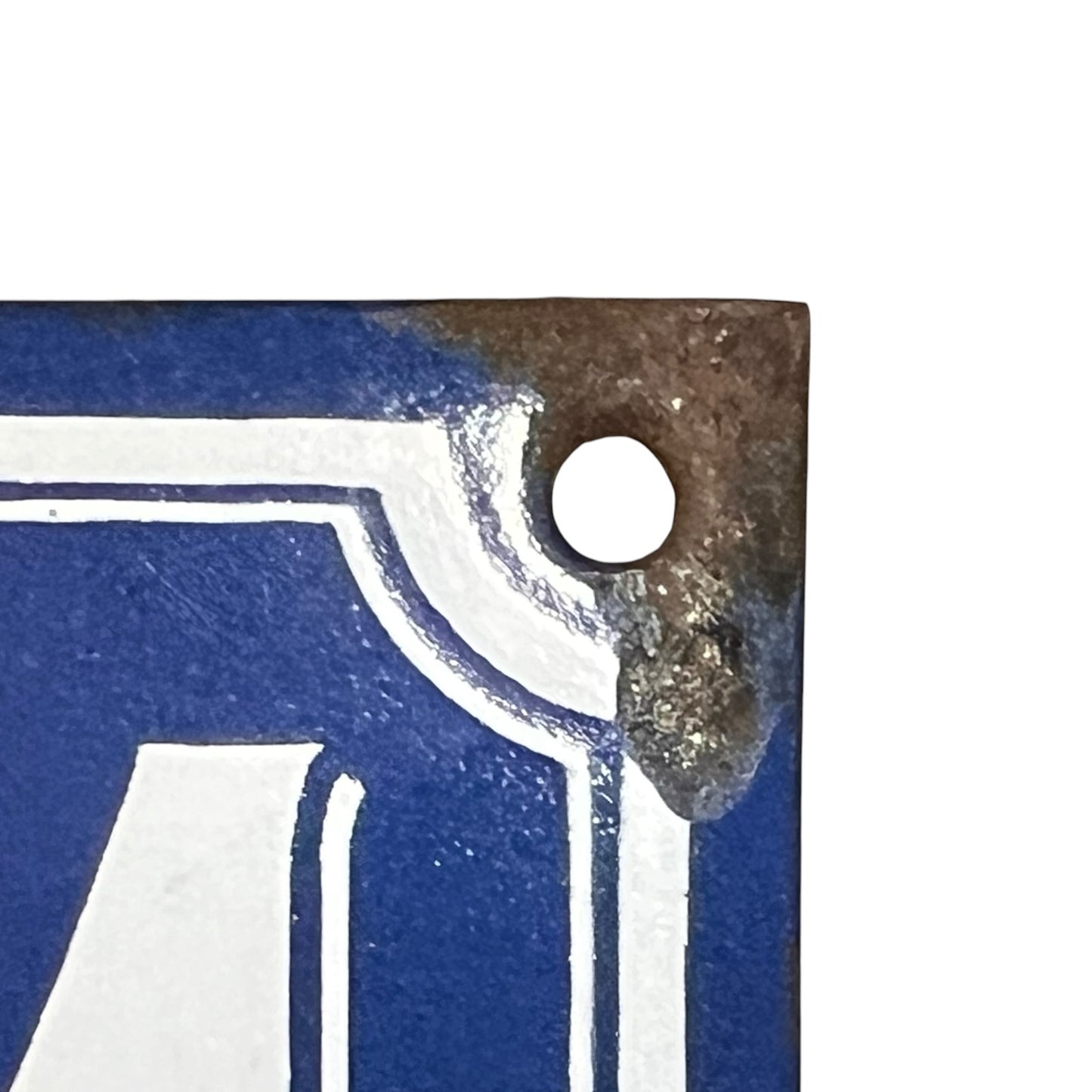 Close-up of a metal object with a hole on a blue background