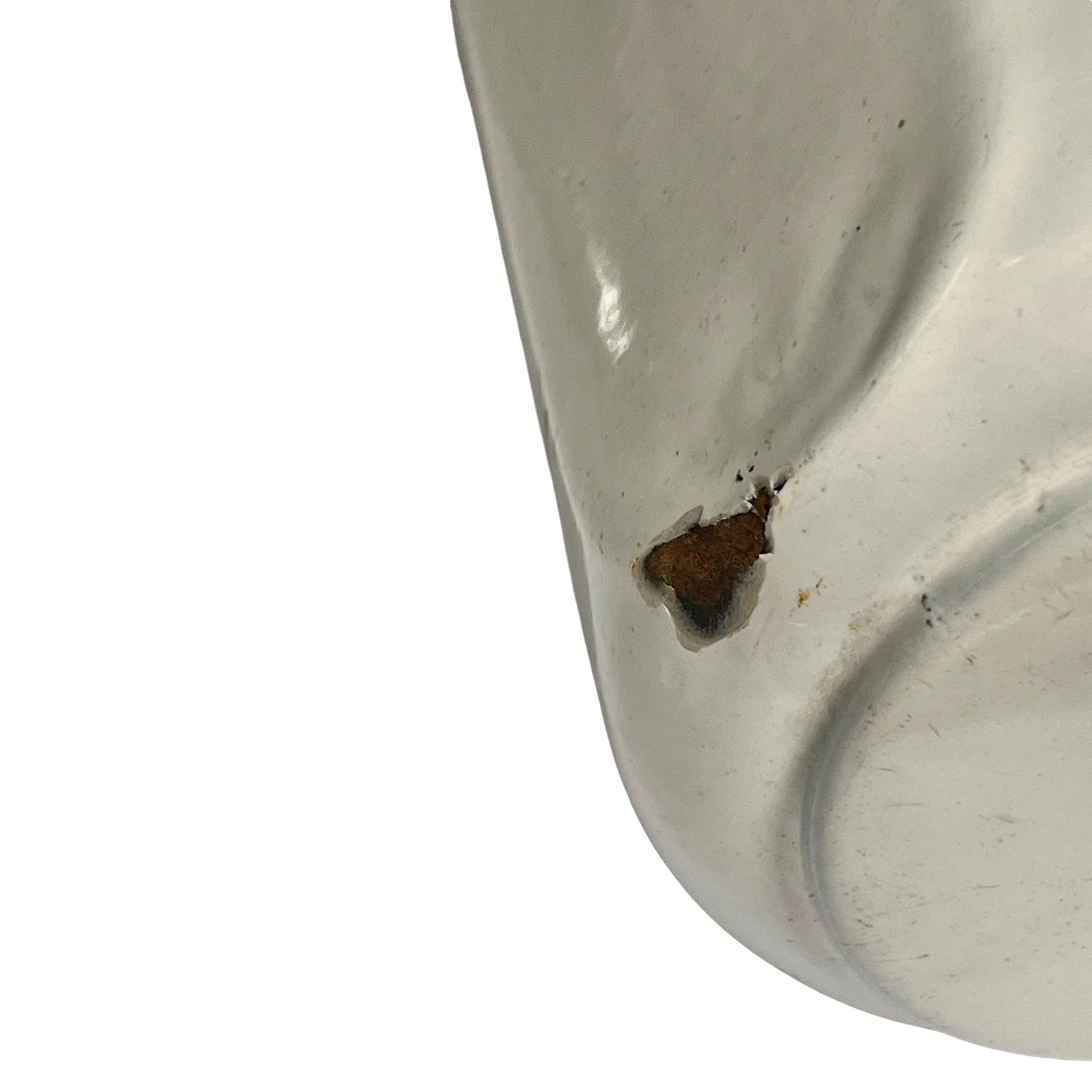 Close-up of a glossy off-white pot with a small brown rust-like stain or defect on the surface, set against a plain white background 