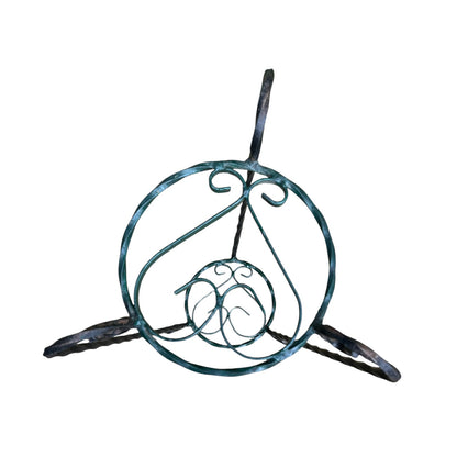Green and black wrought iron jardinière scrolled plant stand on a white background