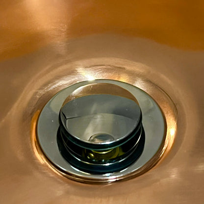 Close up of a copper sink on a white background 