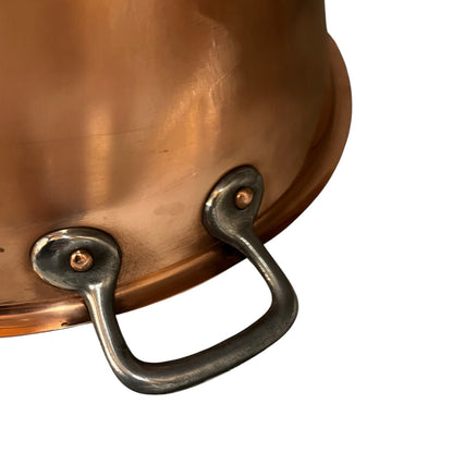 Close up of a French copper bathroom basin on a white background