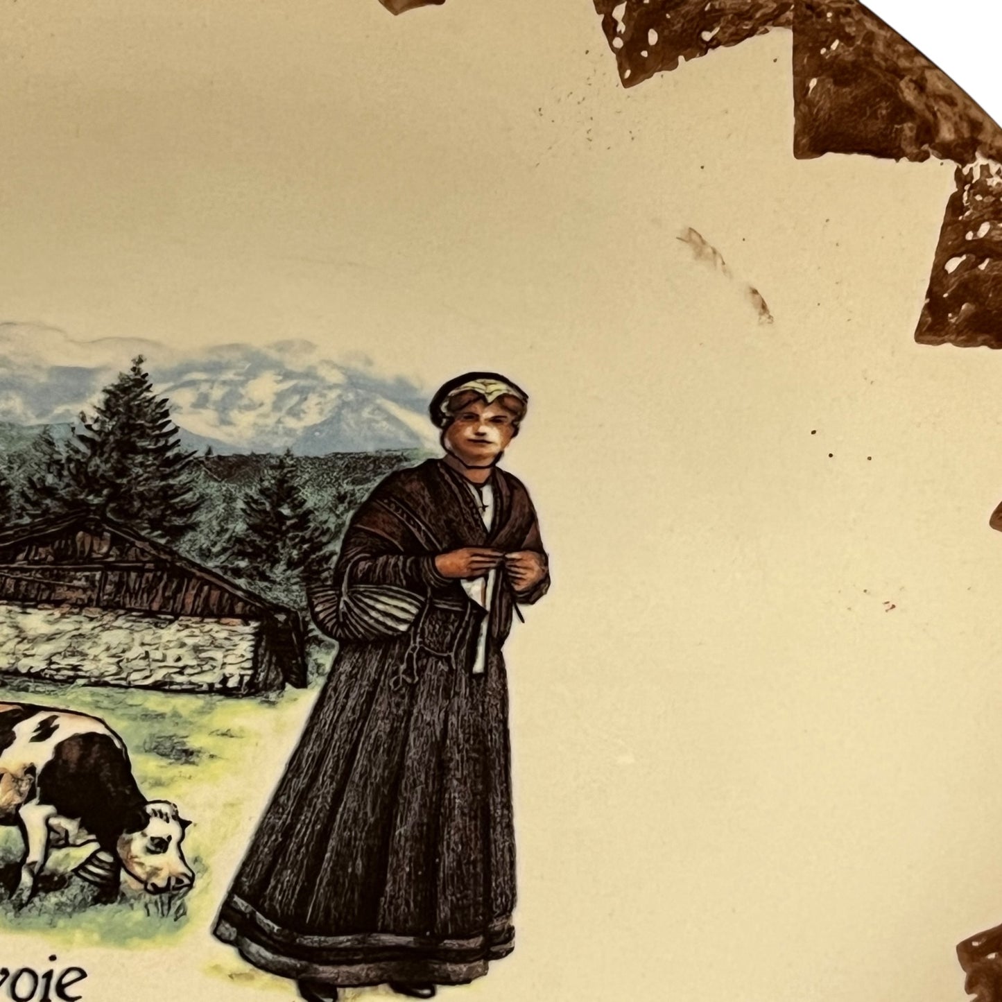 Vintage illustration of a woman in traditional attire with a cow and mountain landscape.