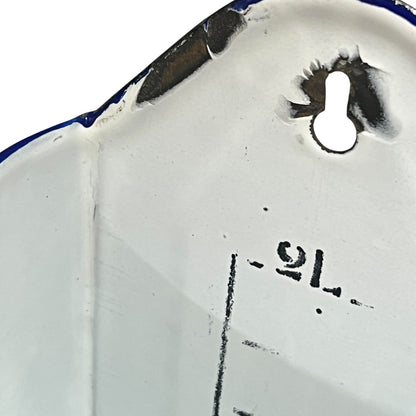 Close up of  French vintage enamel planter with a flat back and a spout on a white background