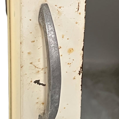 close up of a vintage metal bathroom cabinet