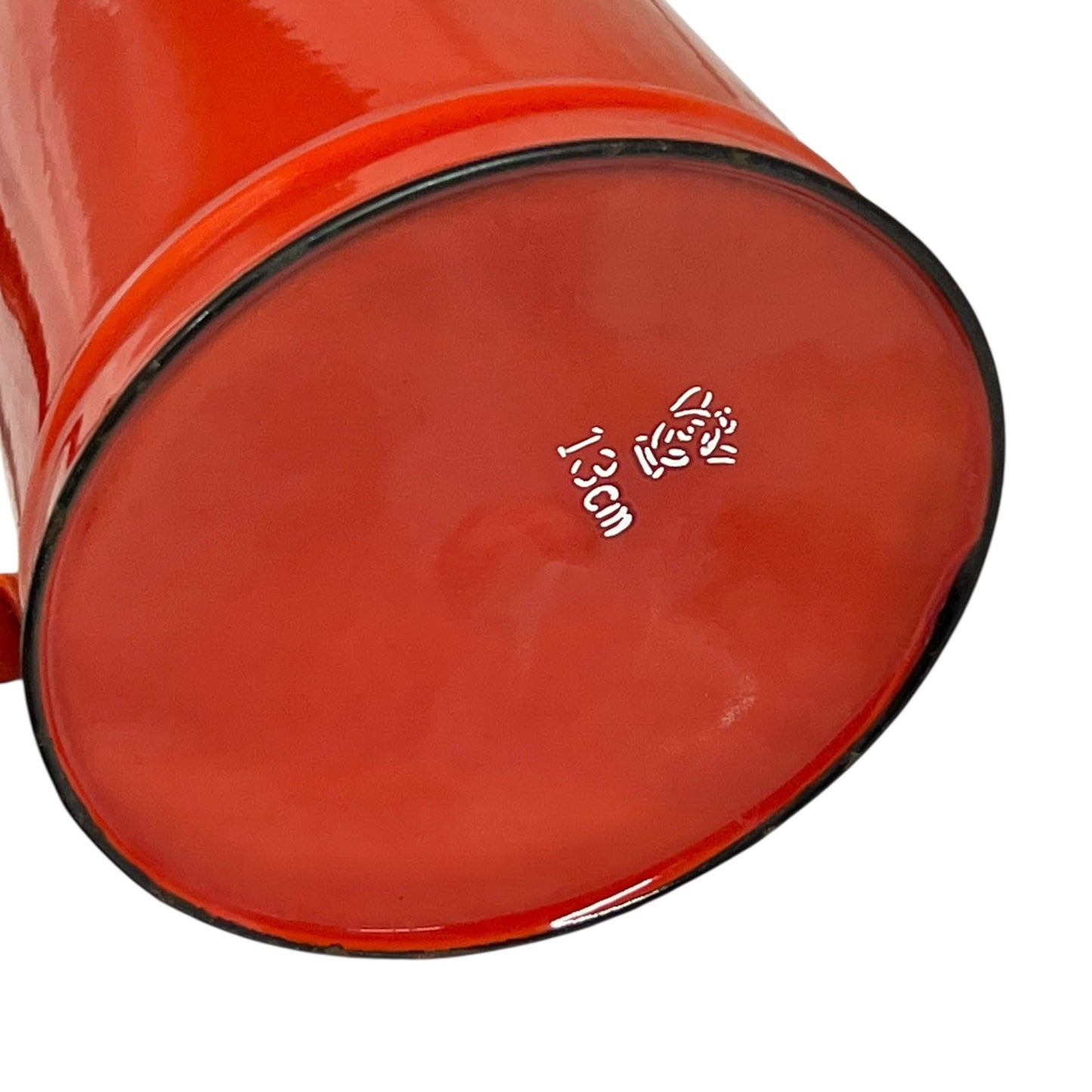 Close up of a red vintage French enamelled coffee pot on a white background