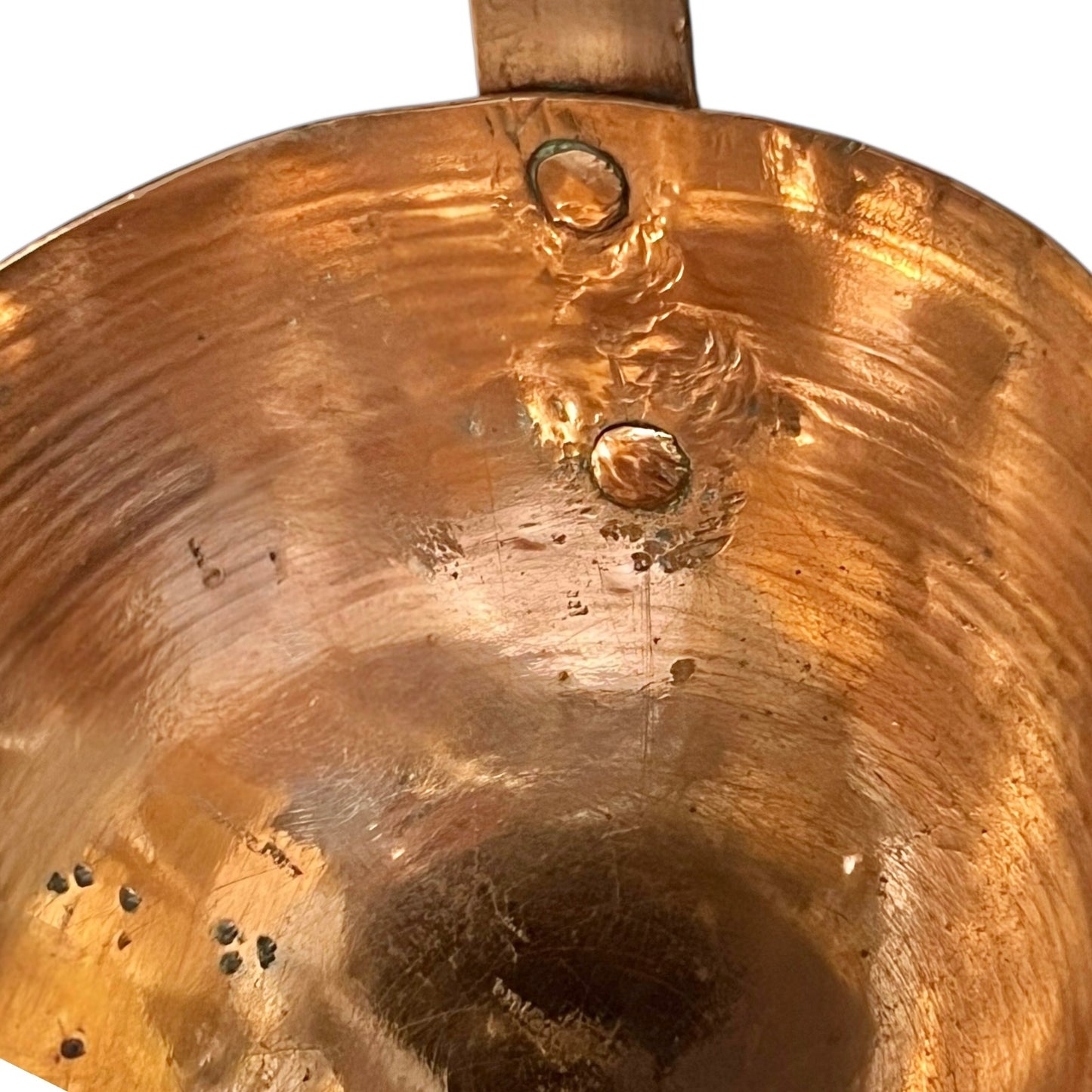 Close up of a French copper handmade ladle on a white background